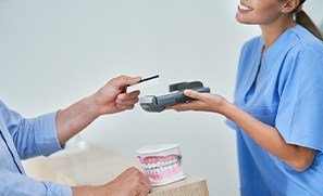 A patient paying for their dental care