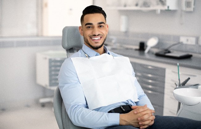 Patient smiling while sitting in treatment chair