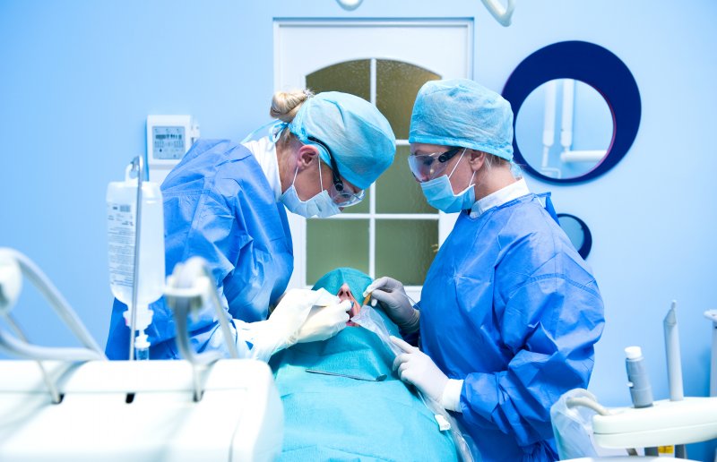 Dentists performing a dental implant surgery